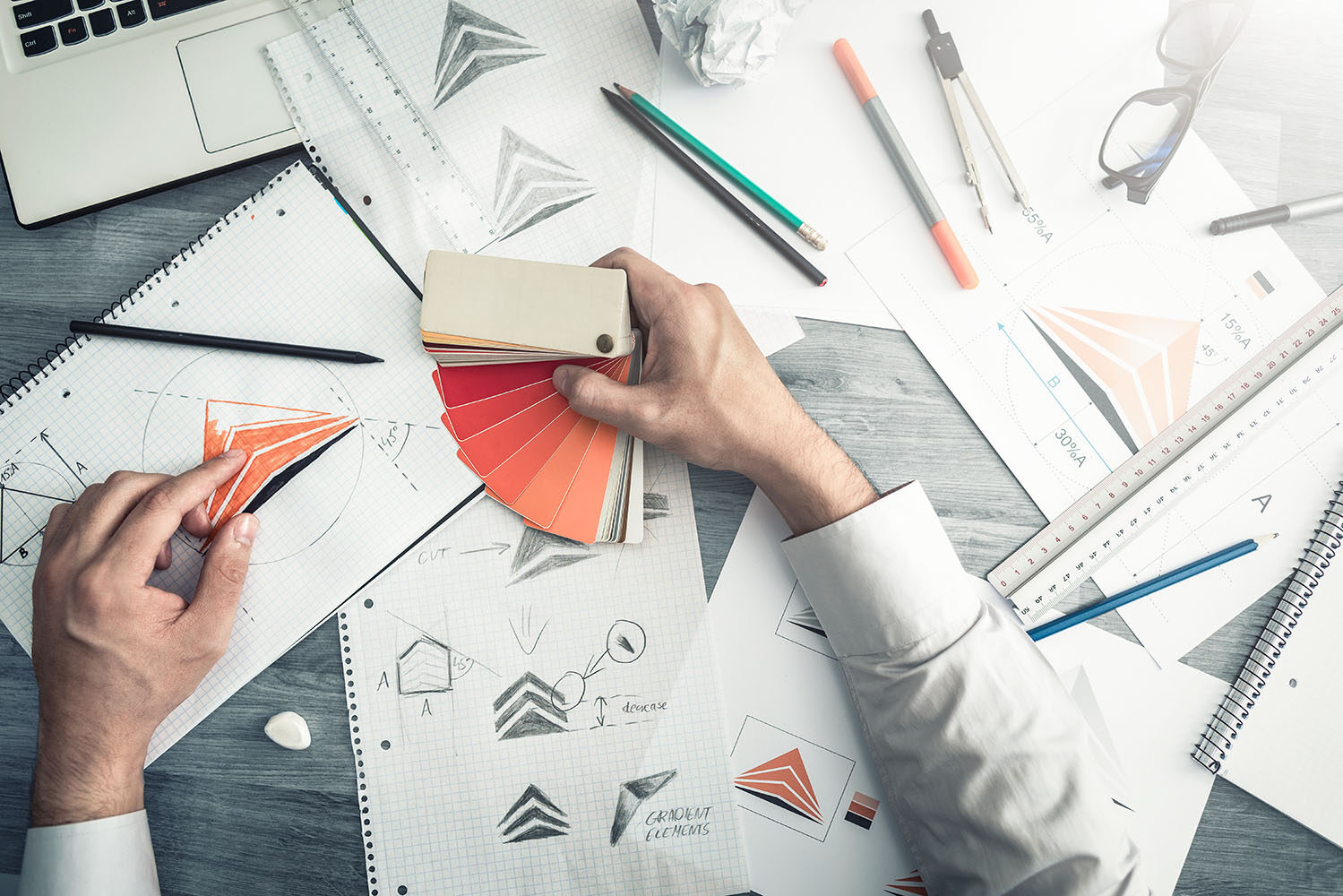 A graphic label designer using swatches to find the rignt color for a project.